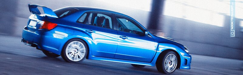 blue performance car in motion