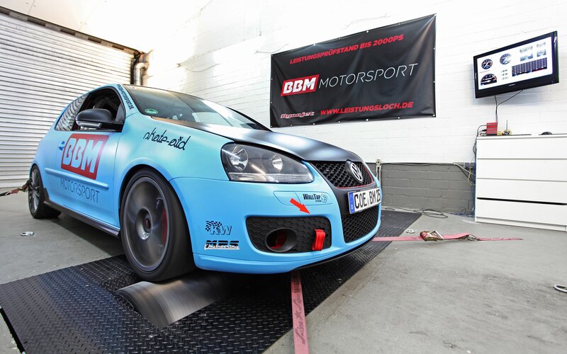 Blue performance car on dynamometer