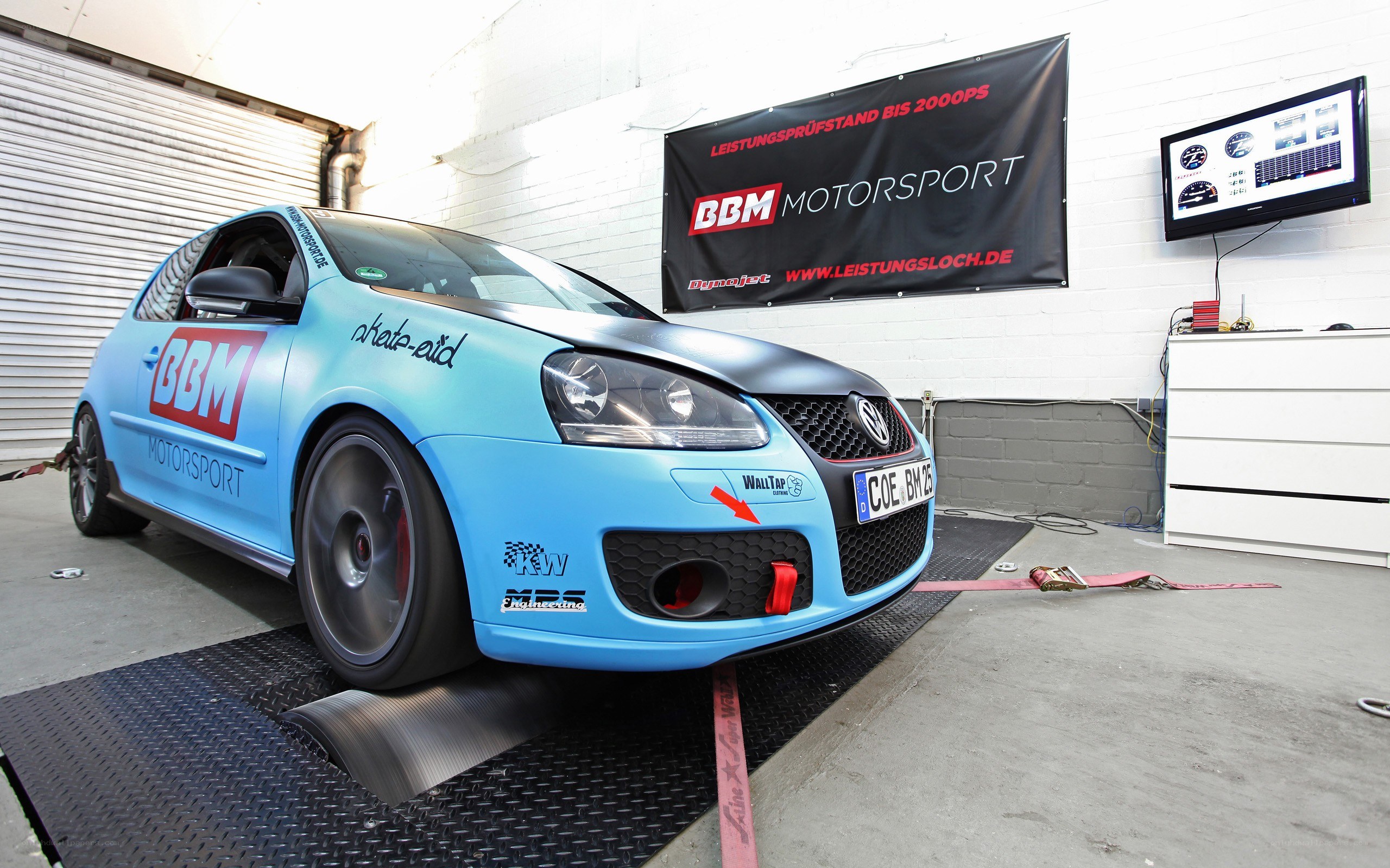 Blue performance car on dynamometer