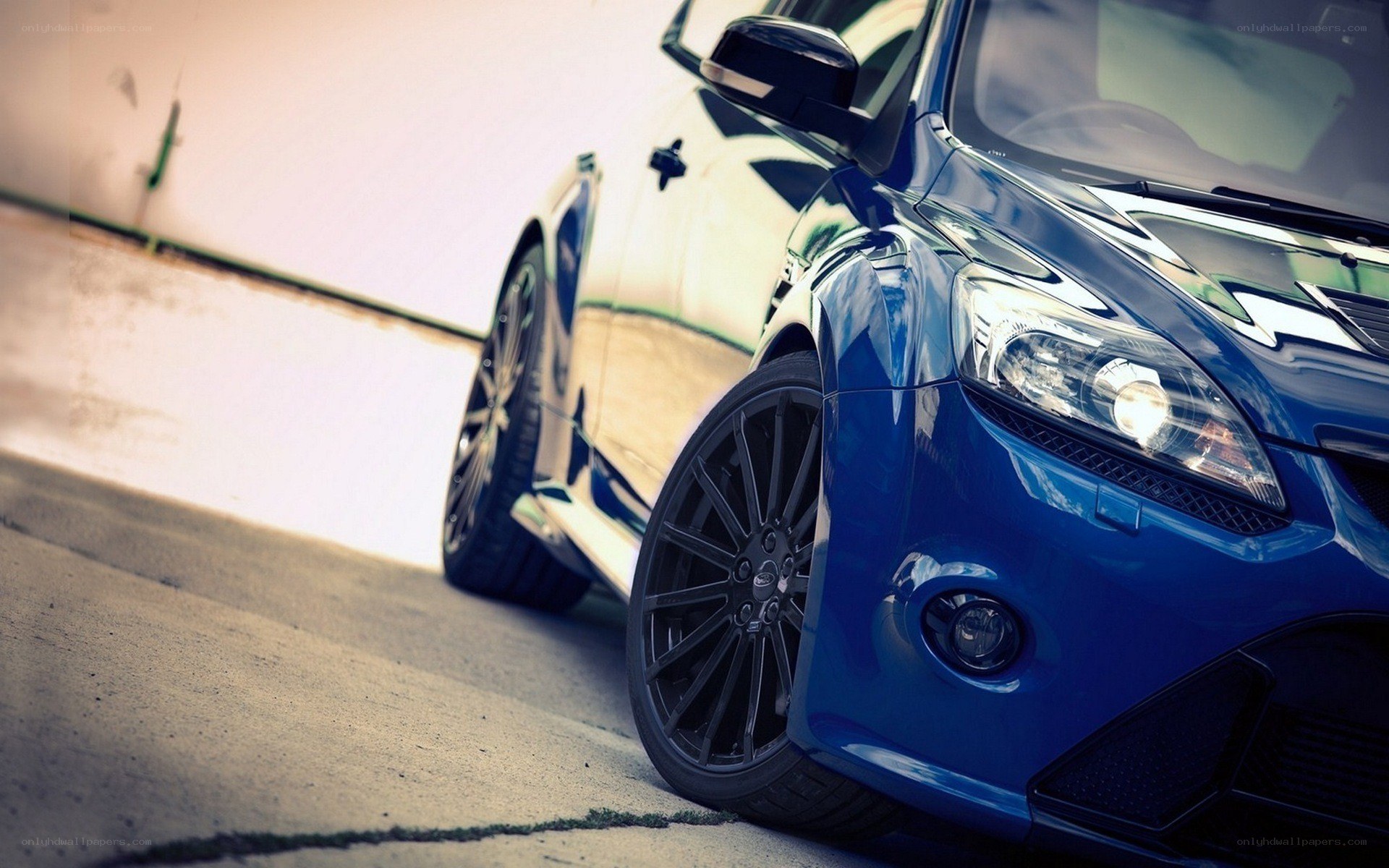 blue performance car on pavement