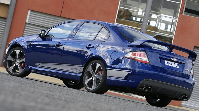 Blue Performance Sedan — Dynamic, Afternoon, Photograph, Car, Building