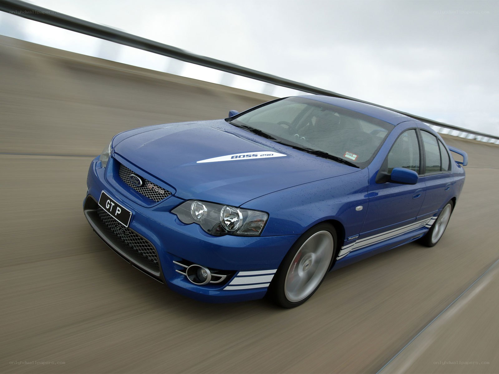 blue performance sedan in motion