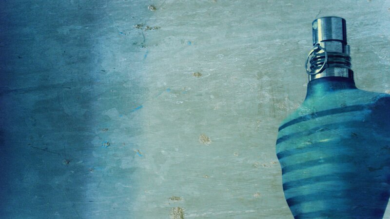 blue perfume bottle on textured surface