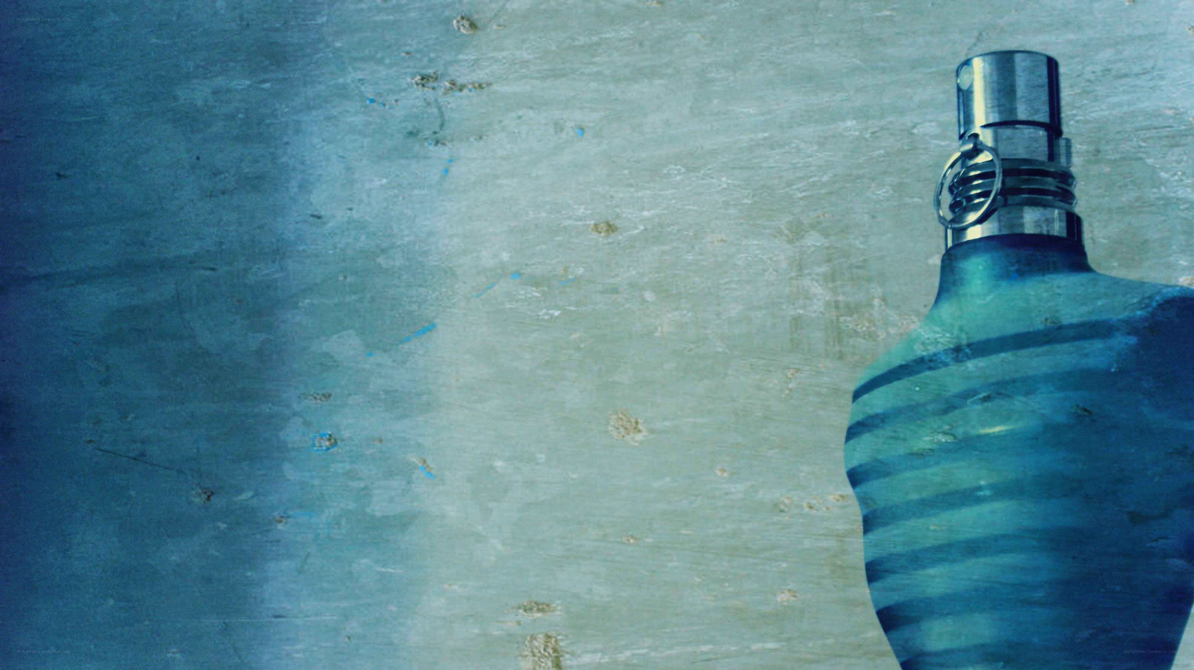 blue perfume bottle on textured surface