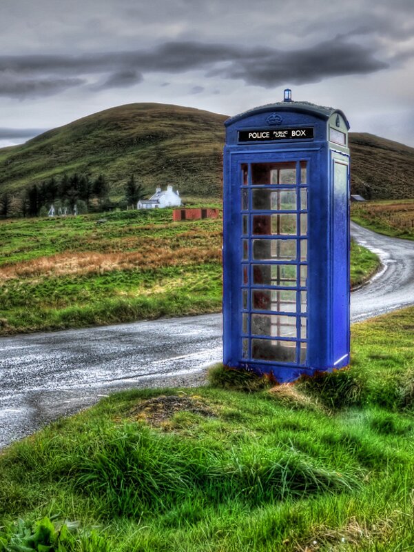 Blue phone box on a rural road