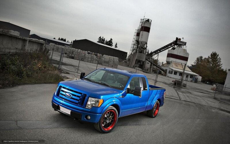 blue pickup truck in industrial area
