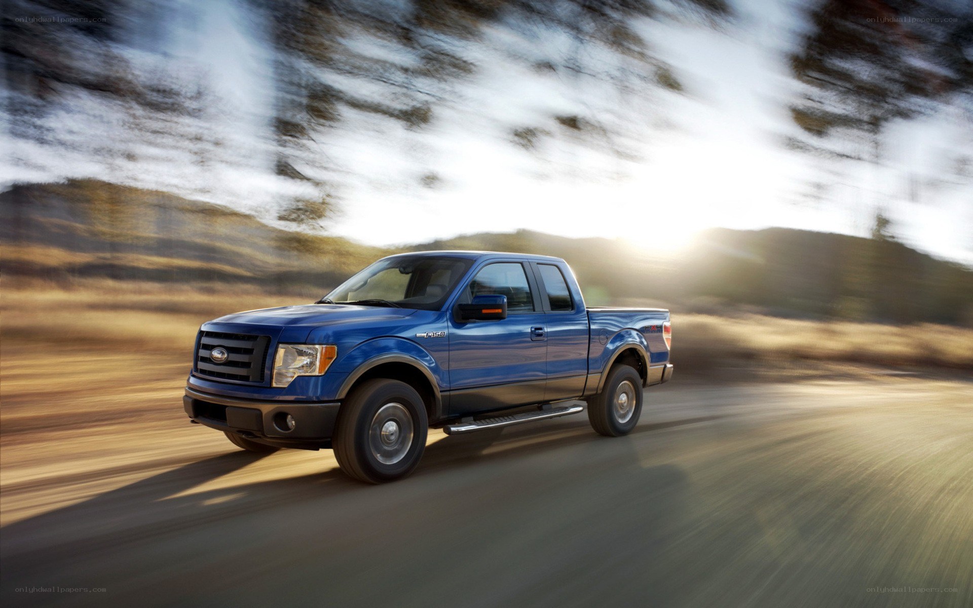 blue pickup truck in motion
