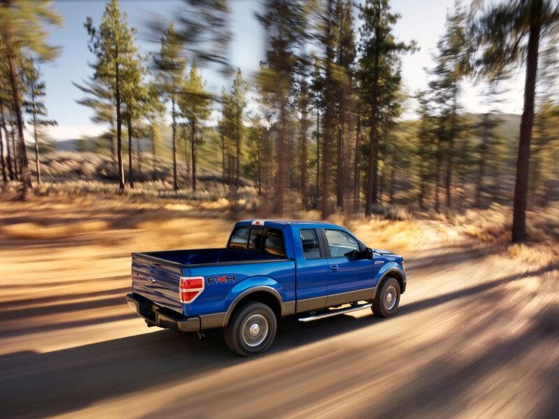 Blue pickup truck on forest road