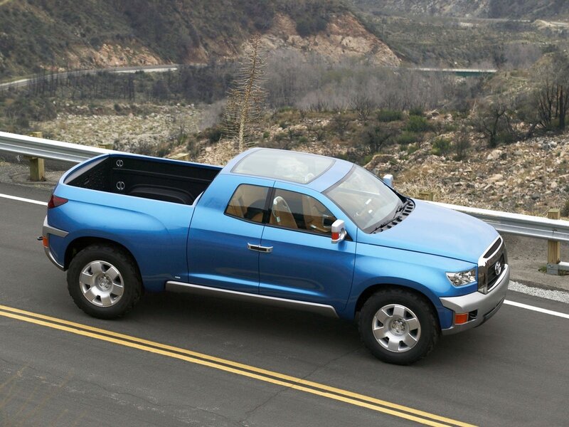 blue pickup truck on mountain road
