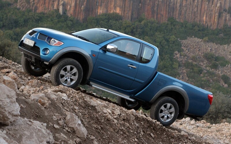 Blue pickup truck on rocky terrain