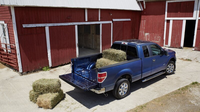 Blue pickup truck with hay bales