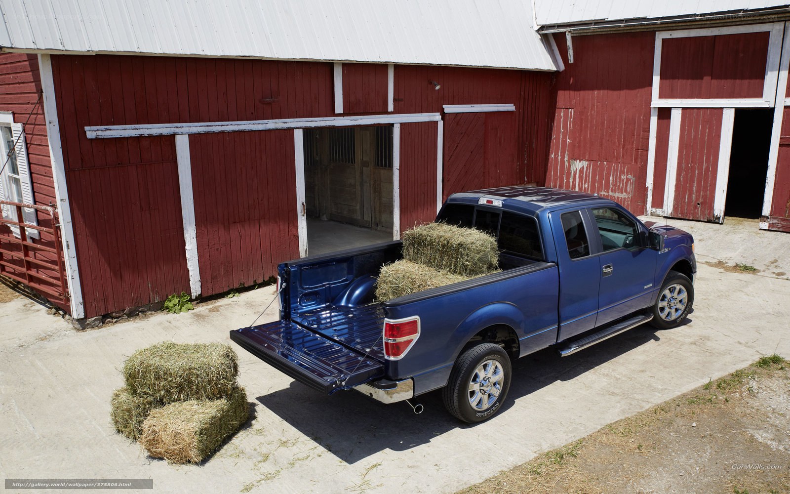 Blue pickup truck with hay bales