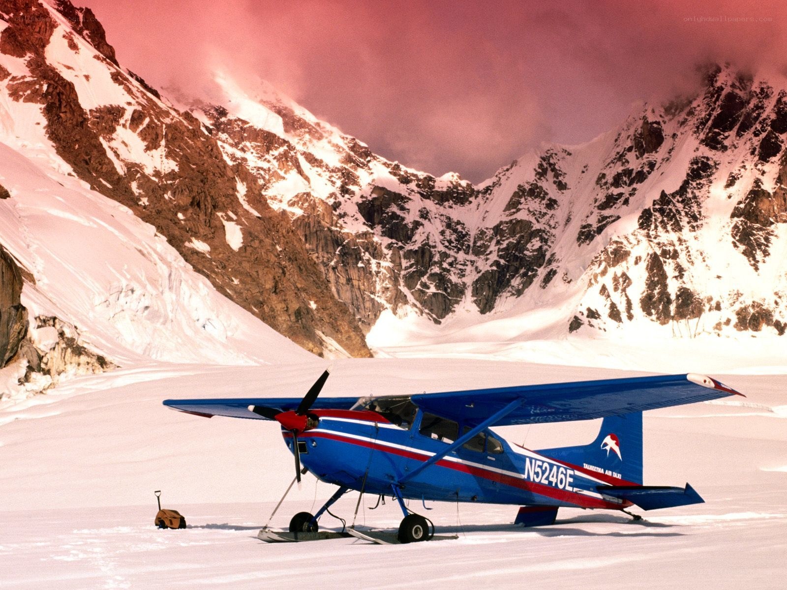 Blue plane on snowy mountain