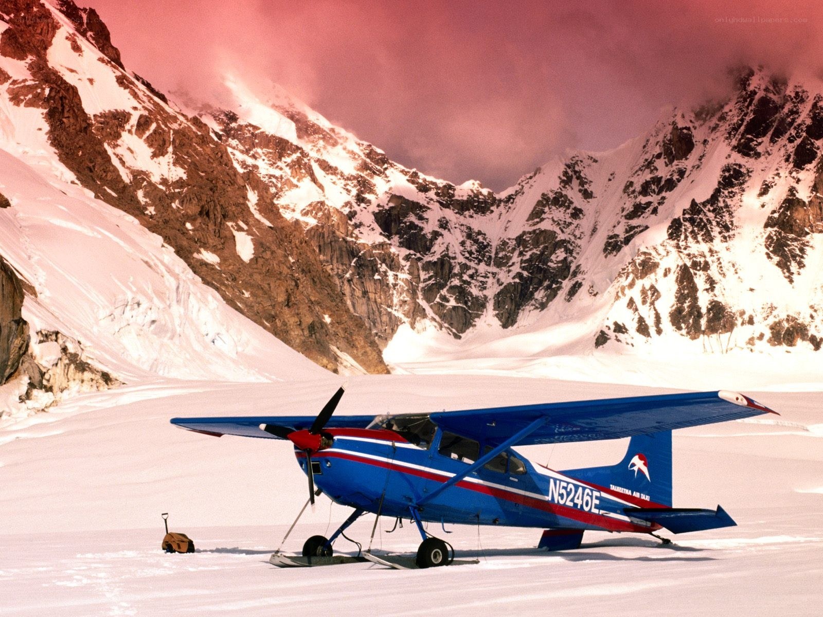 Blue plane on snowy mountain