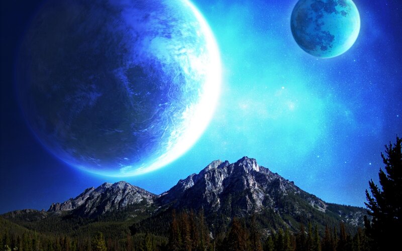 Blue planets over mountain landscape