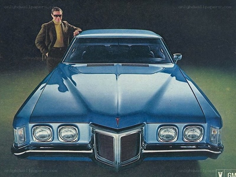 Blue Pontiac car with man