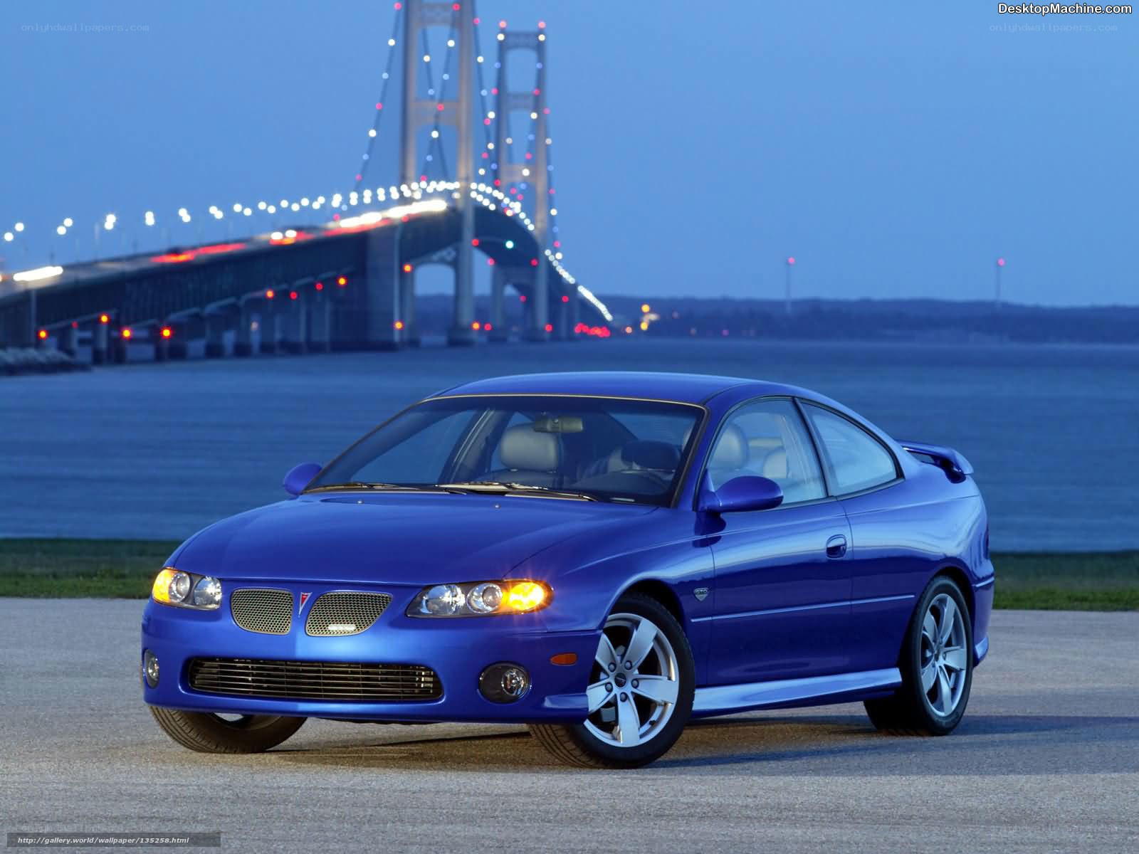 Blue Pontiac GTO by a bridge