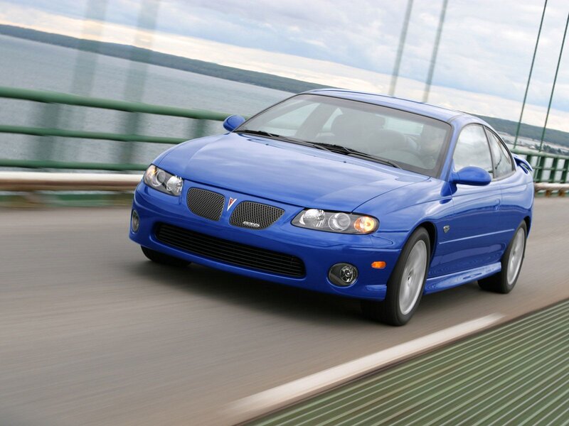 blue pontiac gto on a bridge