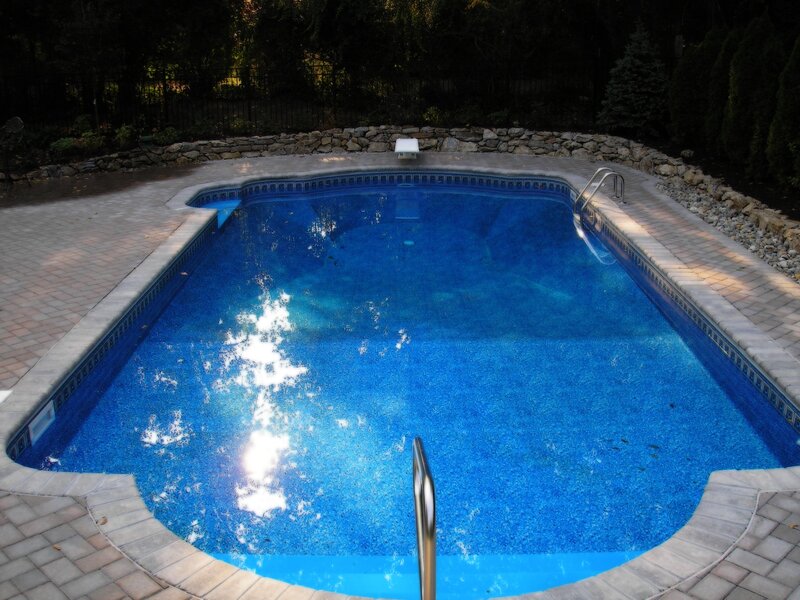 blue pool with stone patio