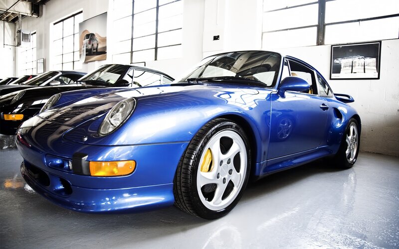Blue Porsche 911 in showroom