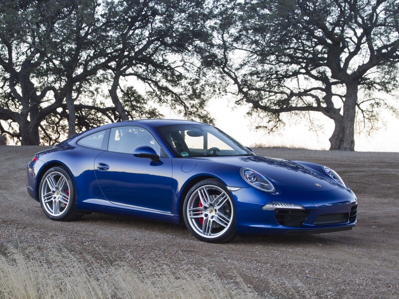 Blue Porsche 911 on a gravel path