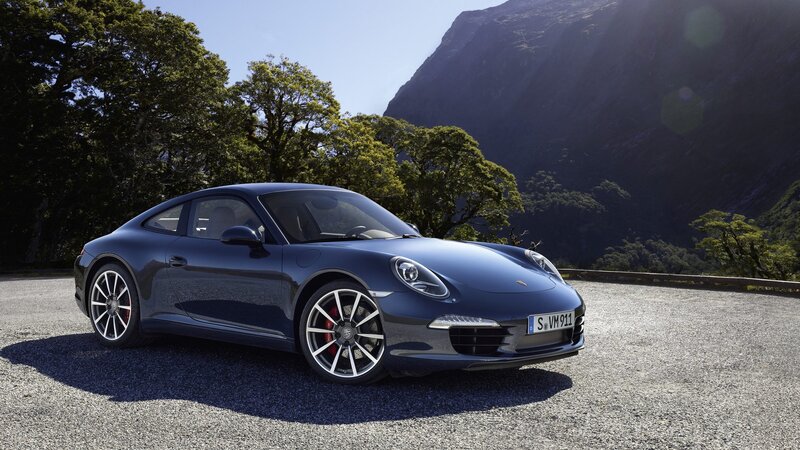 Blue Porsche 911 on a mountain road