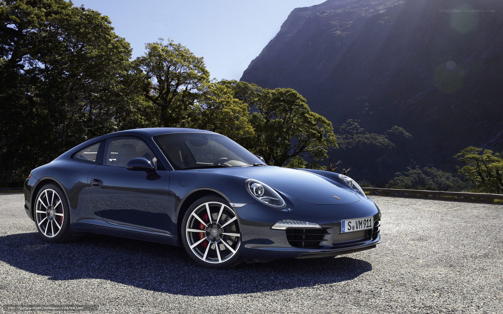 Blue Porsche 911 on a mountain road