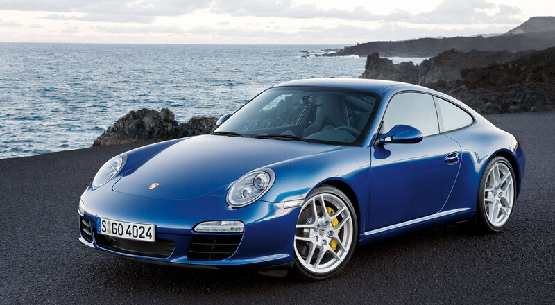 Blue Porsche 911 on coastal road