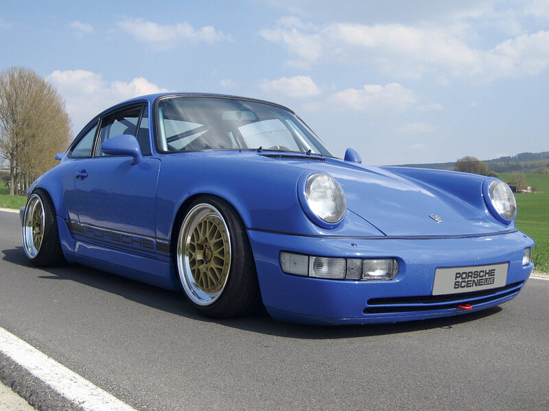 blue porsche 911 on country road