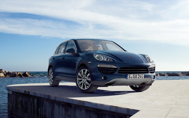 Blue Porsche Cayenne by the sea