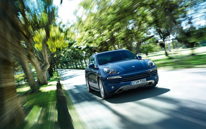 Blue Porsche Cayenne in motion