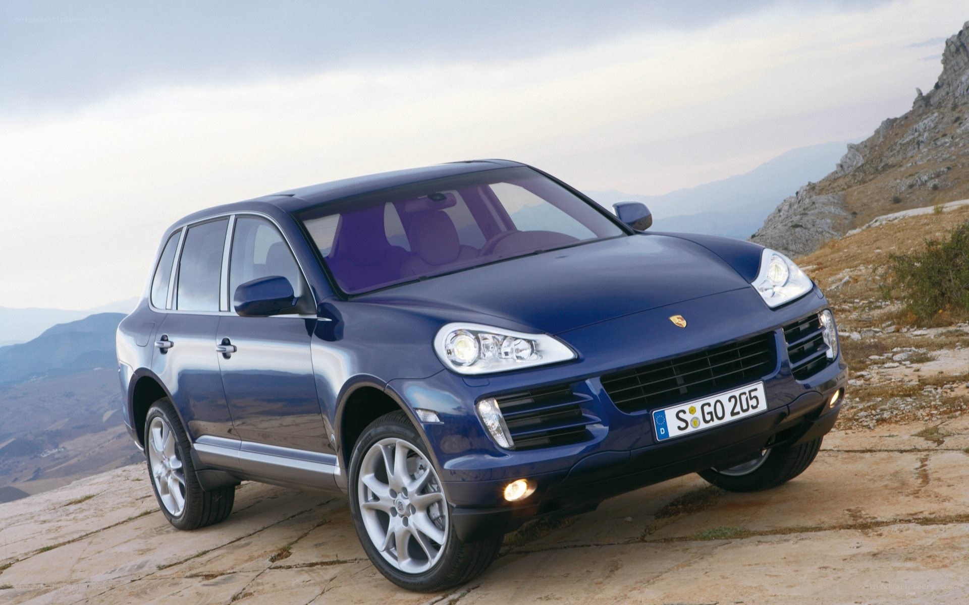 Blue Porsche Cayenne on a mountain