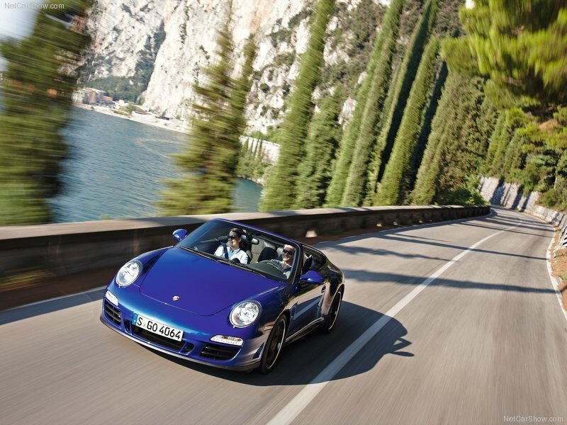 Blue Porsche convertible on a scenic drive