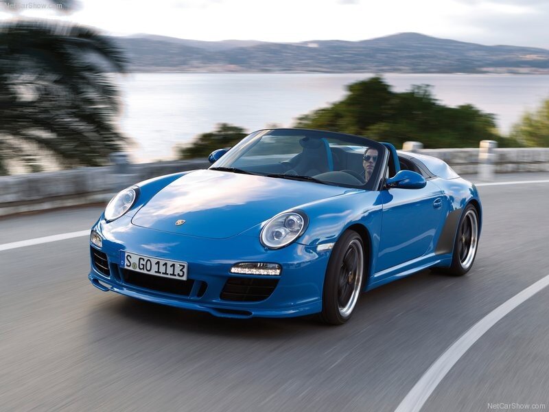 blue porsche convertible on coastal road