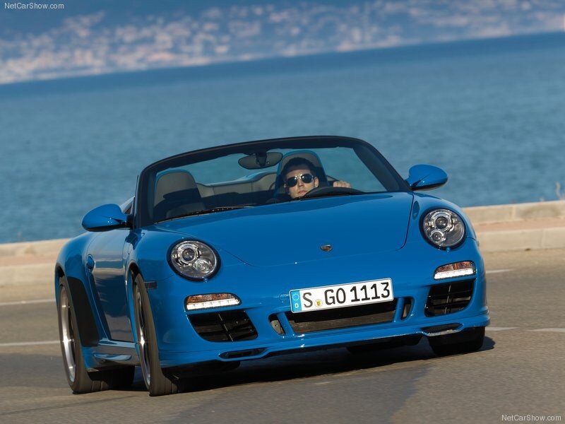 Blue Porsche convertible on coastal road