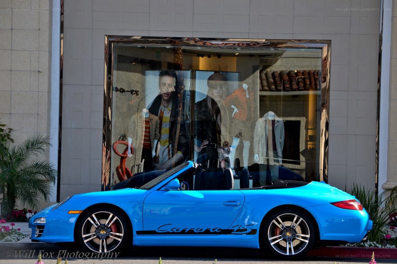 Blue Porsche convertible on street