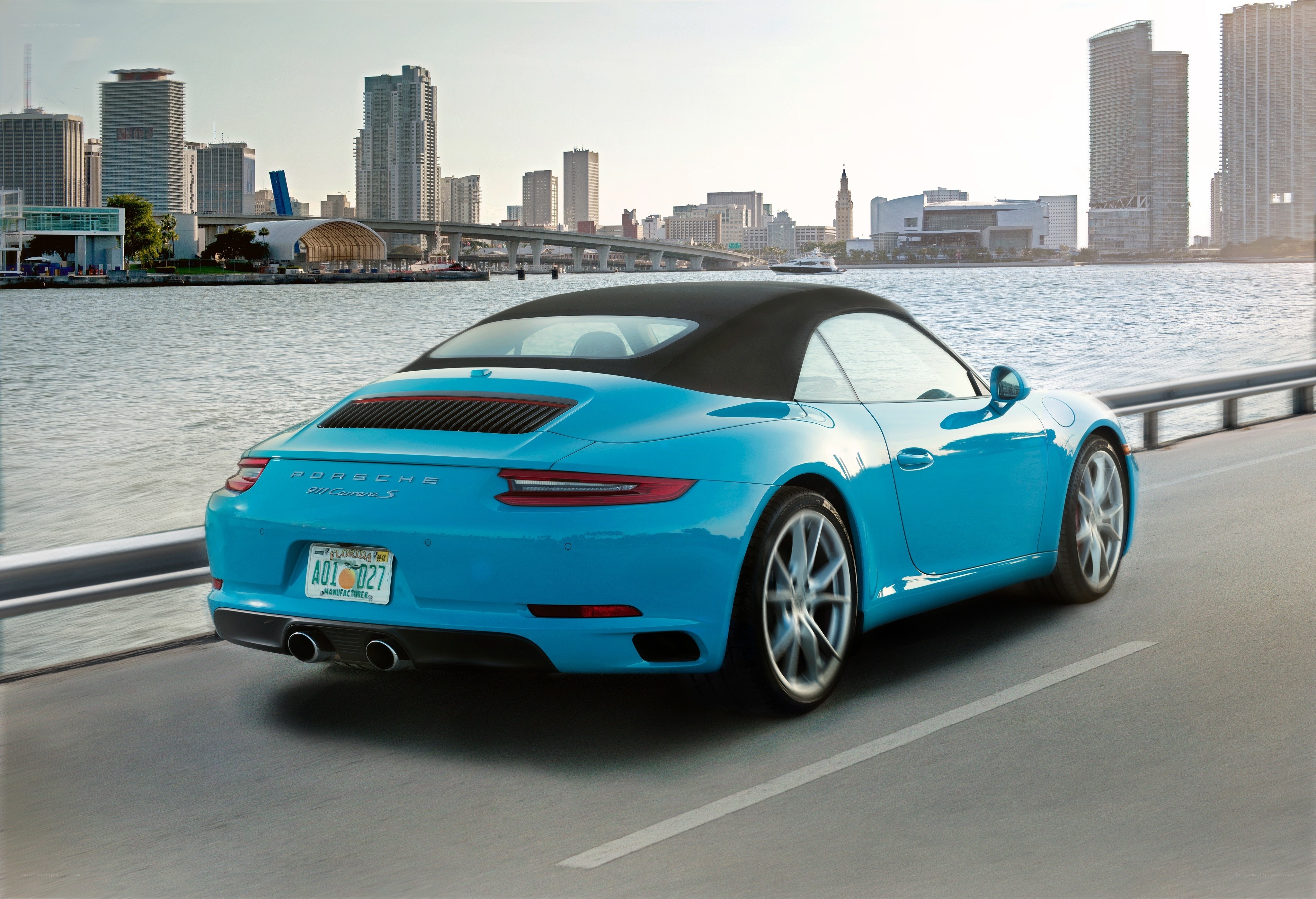 Blue Porsche convertible on waterfront
