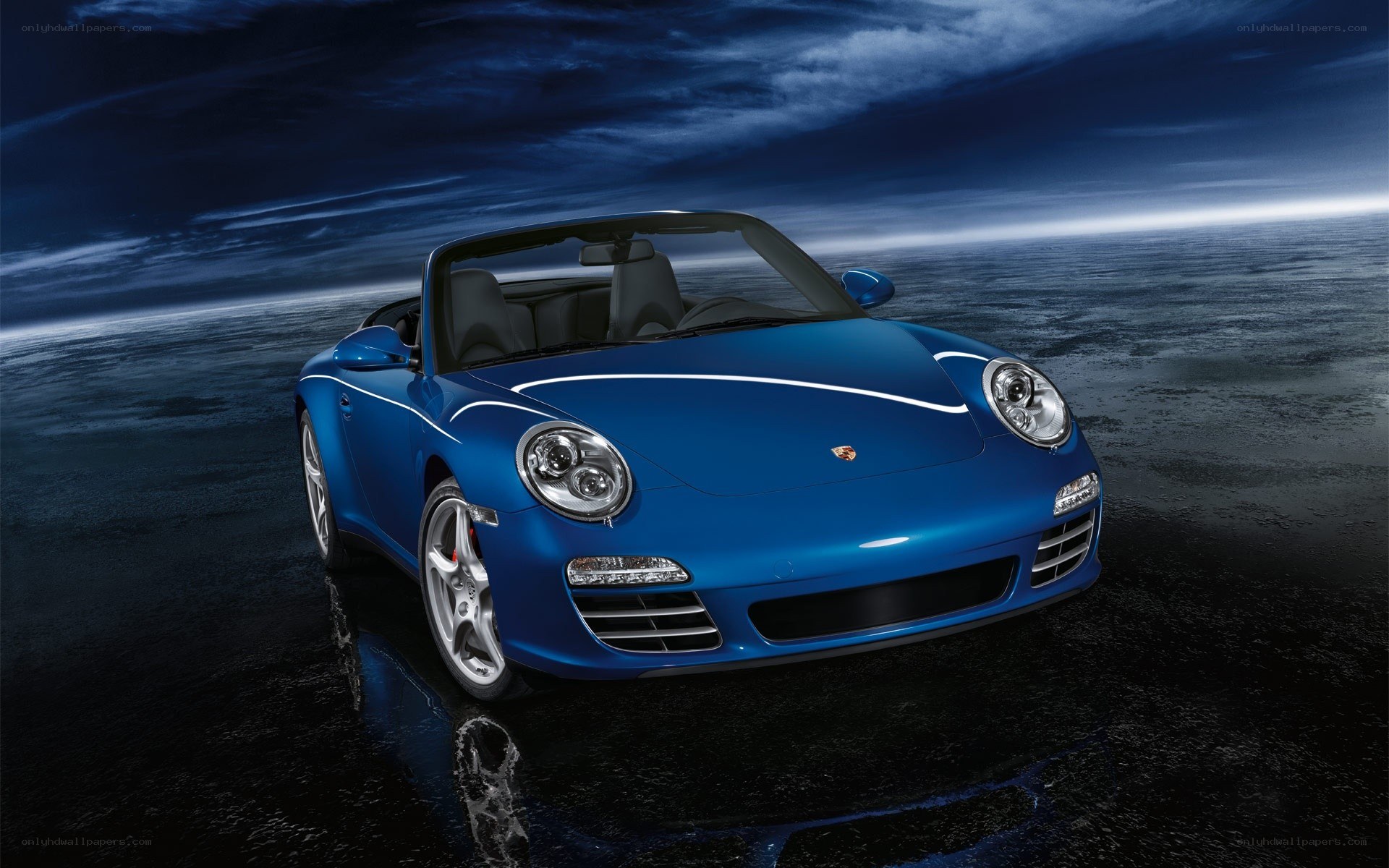 Blue Porsche convertible on wet surface