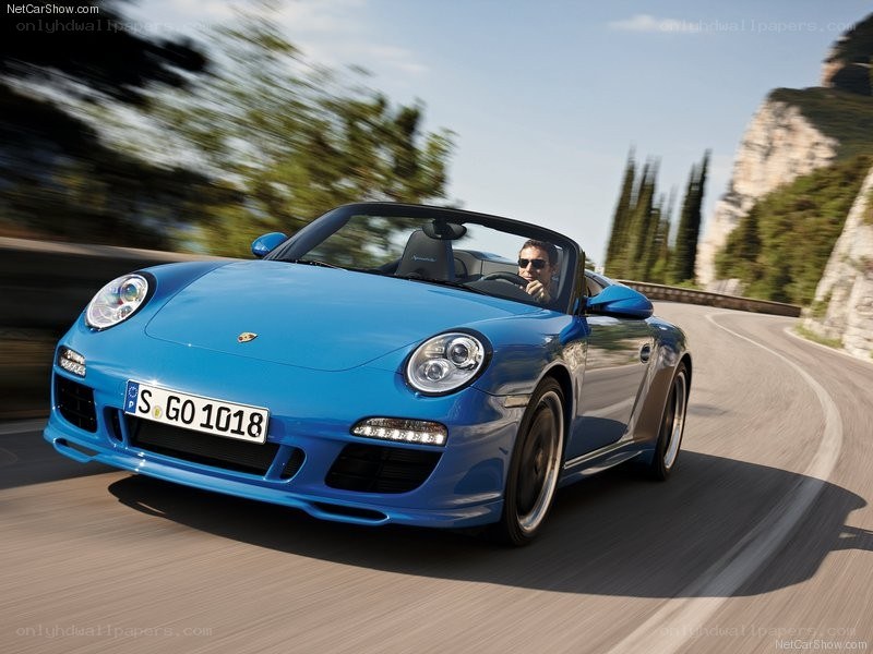 blue porsche driving on road