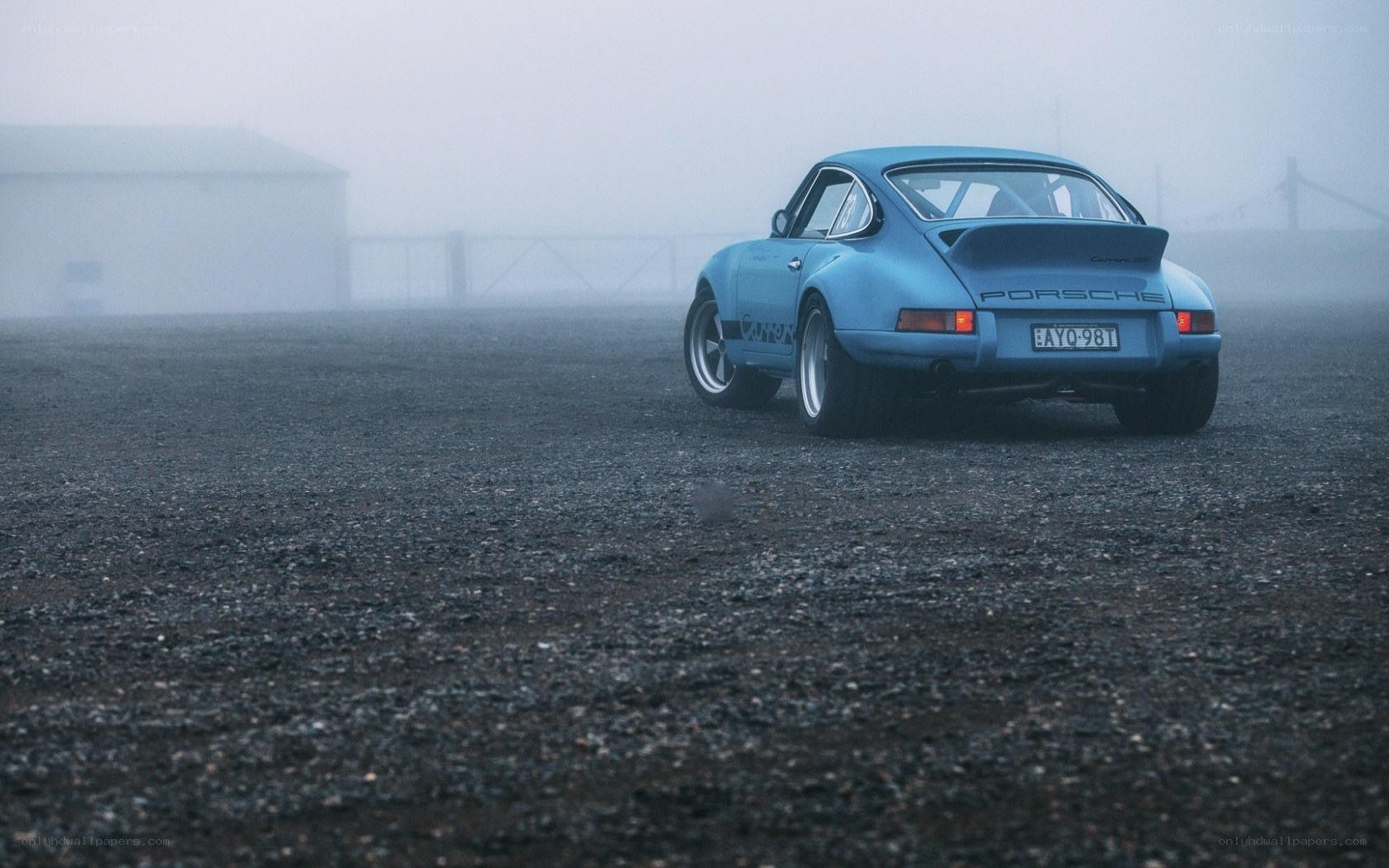 Blue Porsche in foggy lot