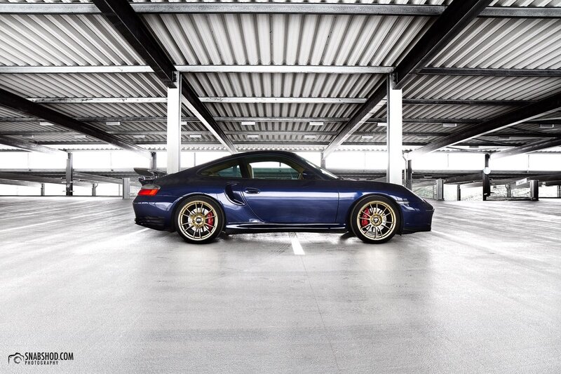 blue porsche in parking garage