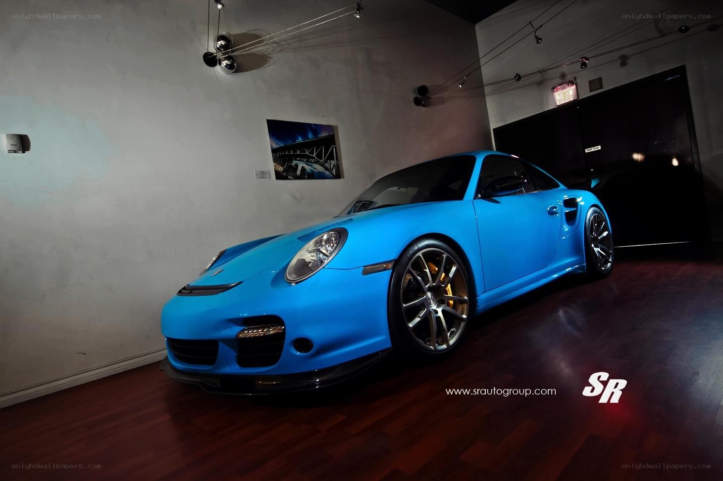blue porsche in showroom