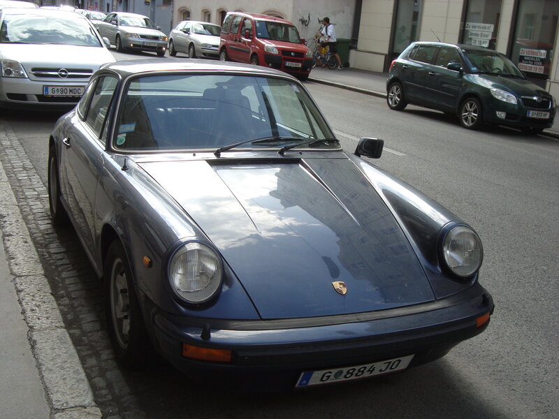 Blue Porsche on a city street