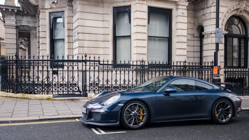 Blue Porsche on a city street