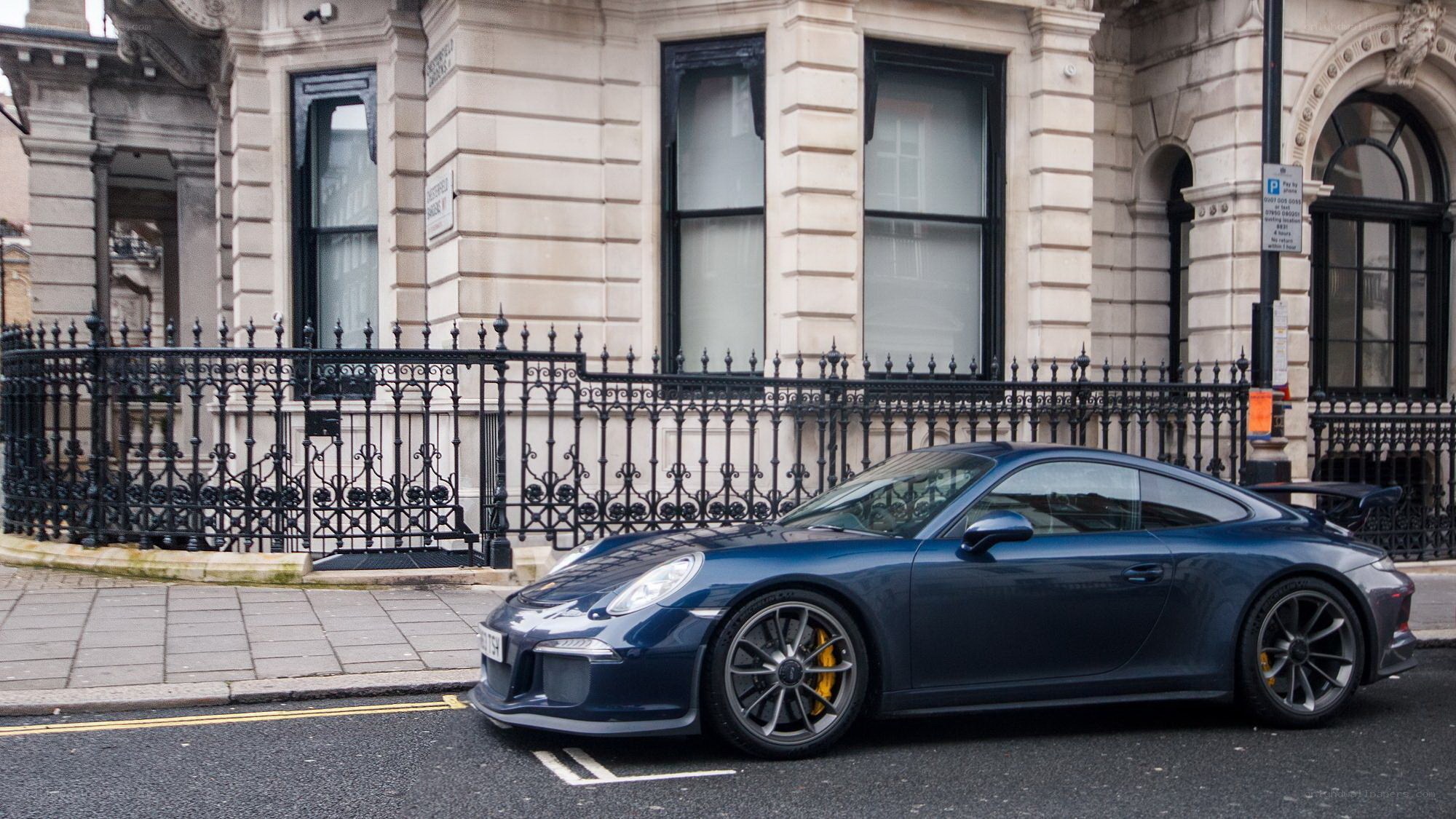 Blue Porsche on a city street