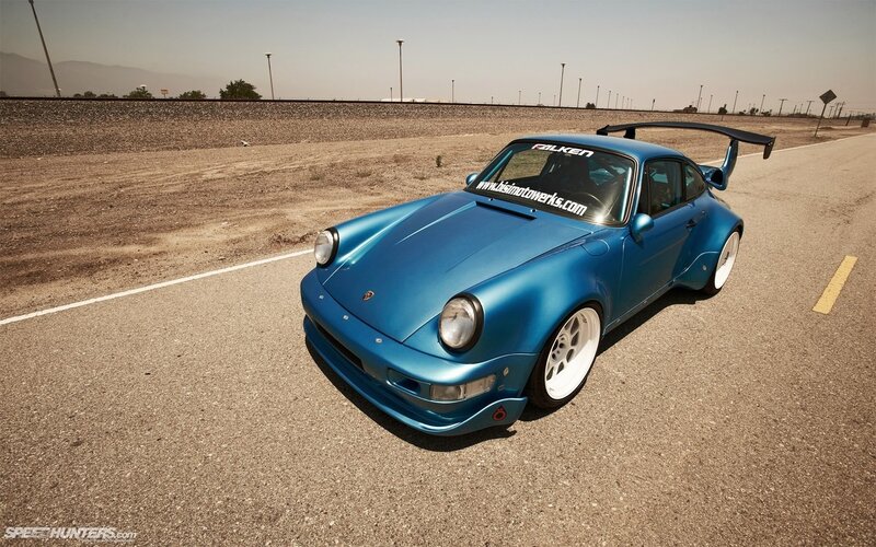 Blue Porsche on a desert road