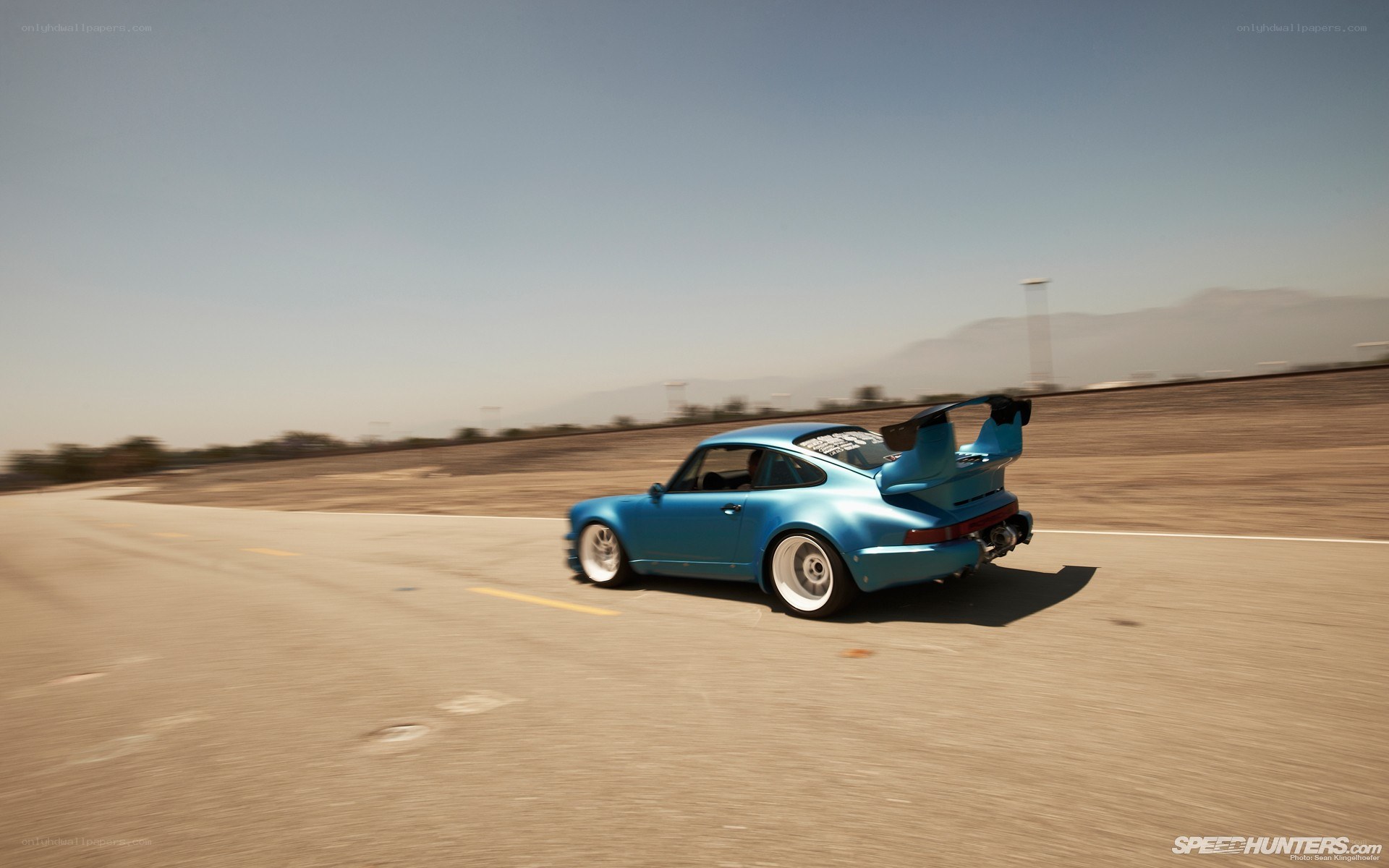 blue porsche on a racetrack