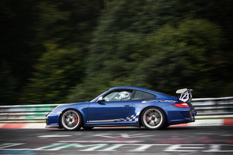 Blue Porsche on a racetrack