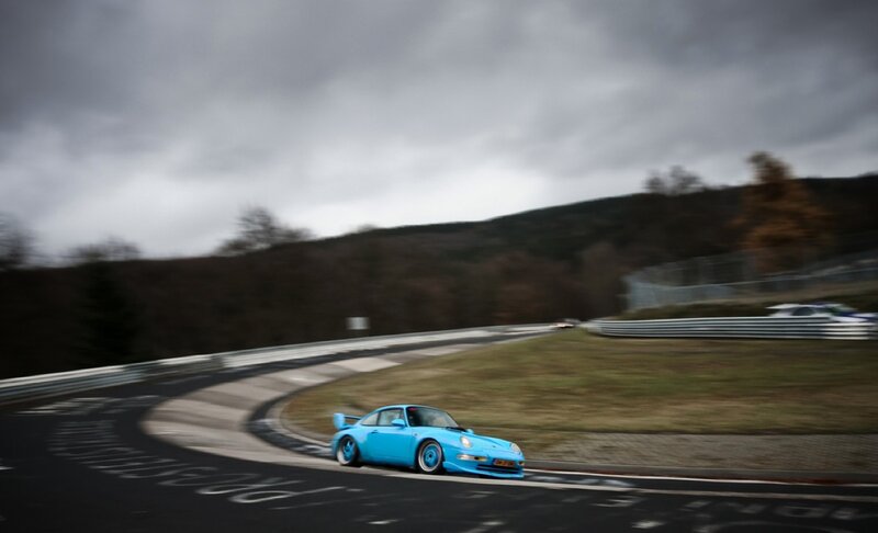 Blue Porsche on a racetrack