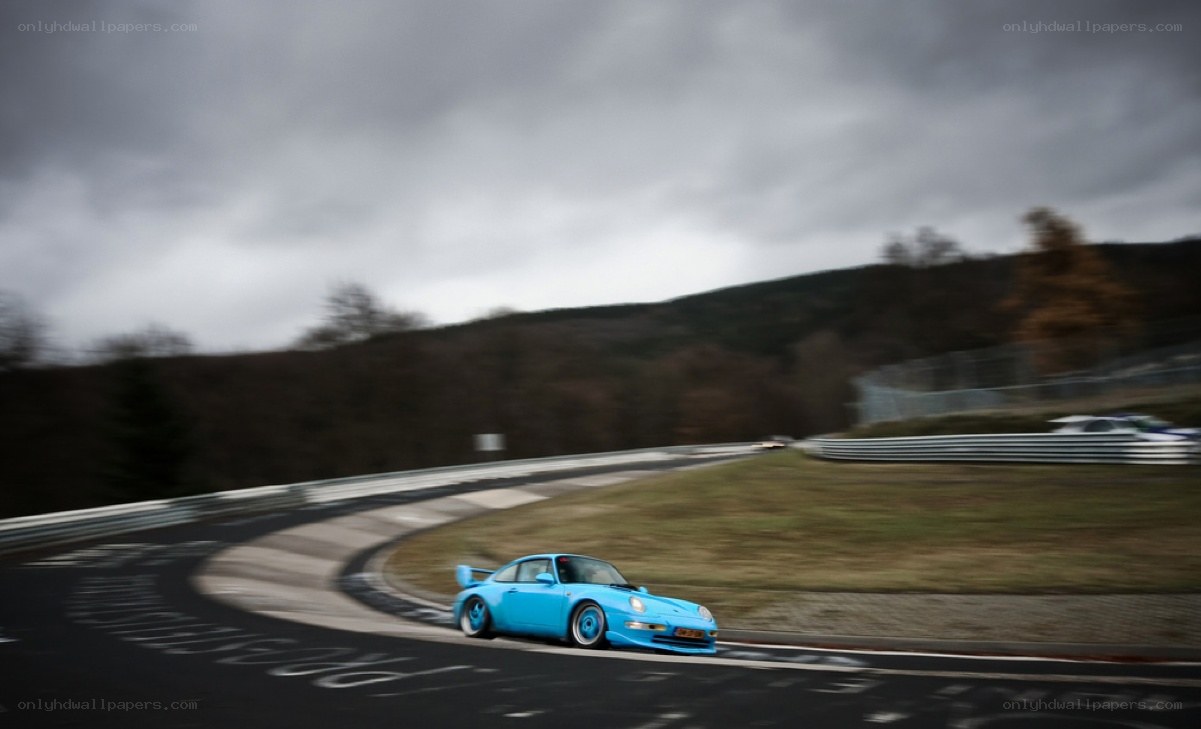 Blue Porsche on a racetrack